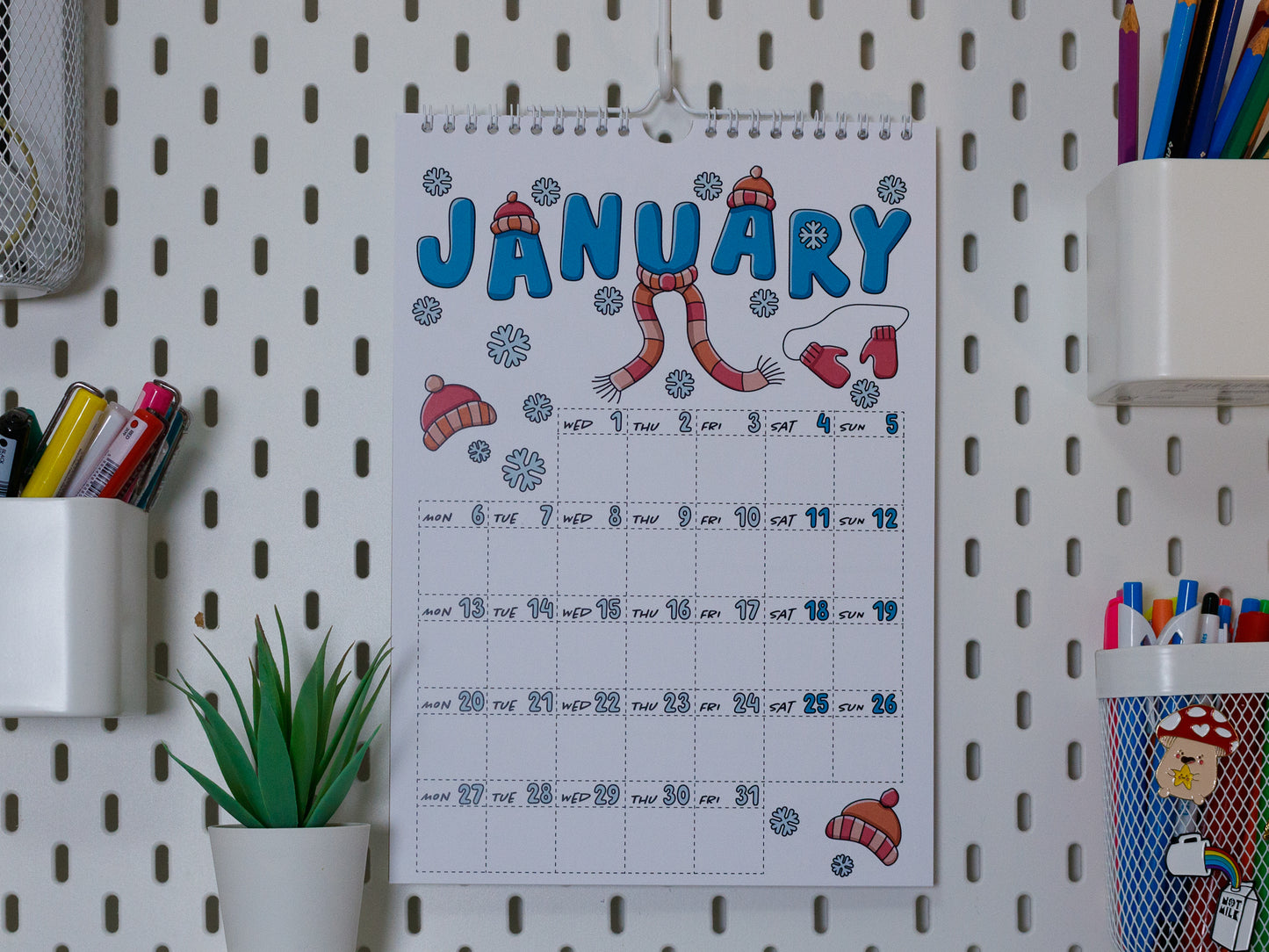 2025 Colourful Wall Calendar hanging on office peg board - January with Snow Design
