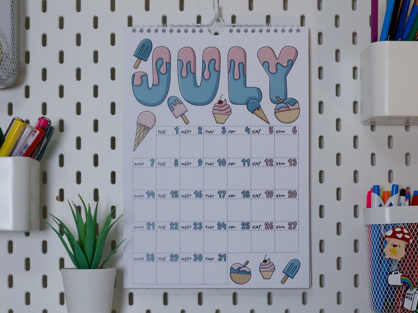 2025 Colourful Wall Calendar hanging on office peg board - July with Ice Cream Design
