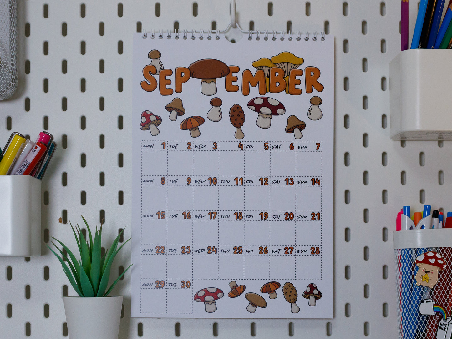 2025 Colourful Wall Calendar hanging on office peg board - September with Mushroom Design