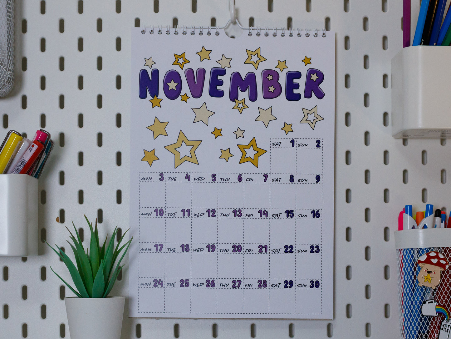 2025 Colourful Wall Calendar hanging on office peg board - November with Star Design