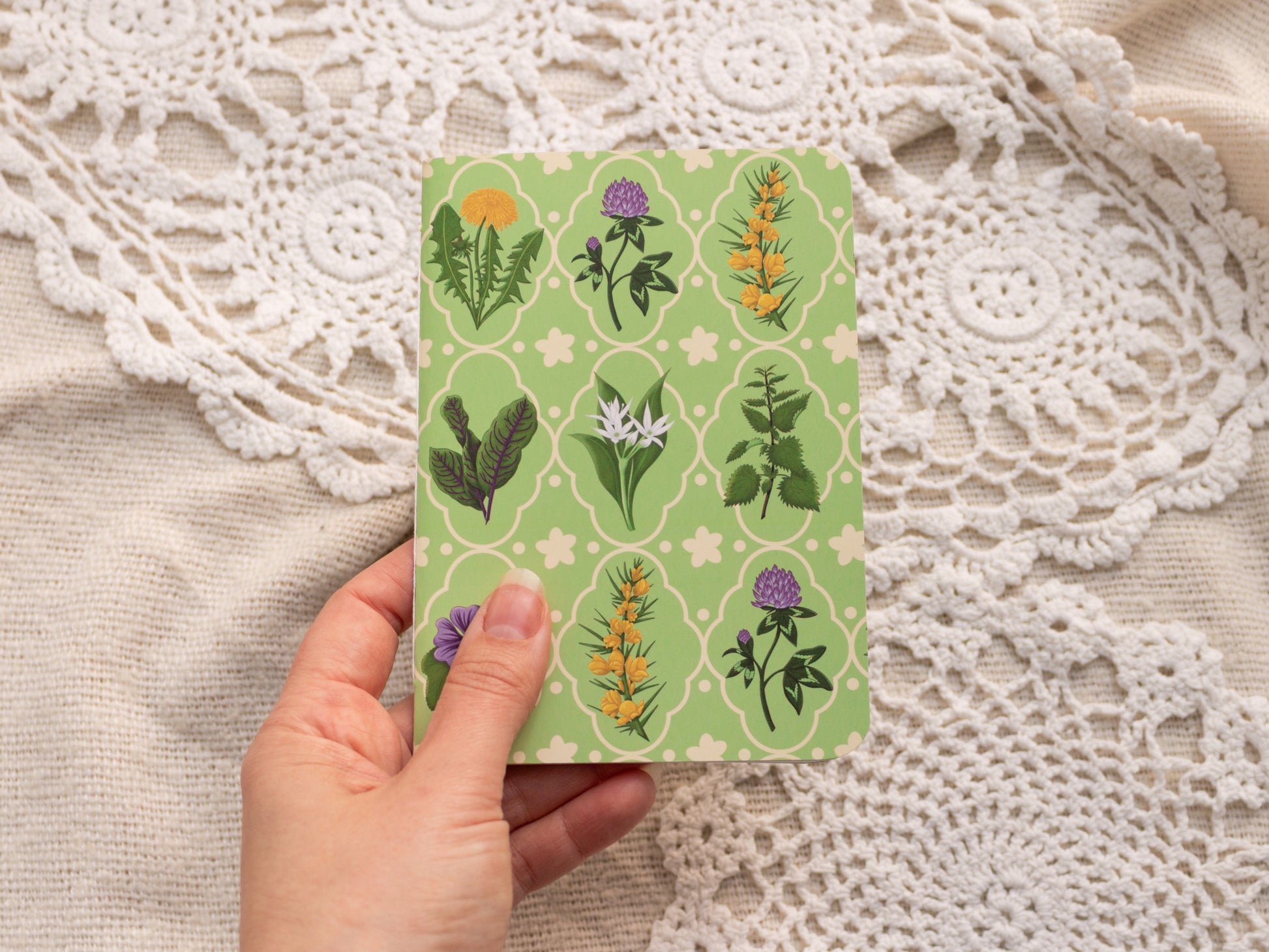 A6 Handmade Notebook with Spring Foraging Design - held in hand