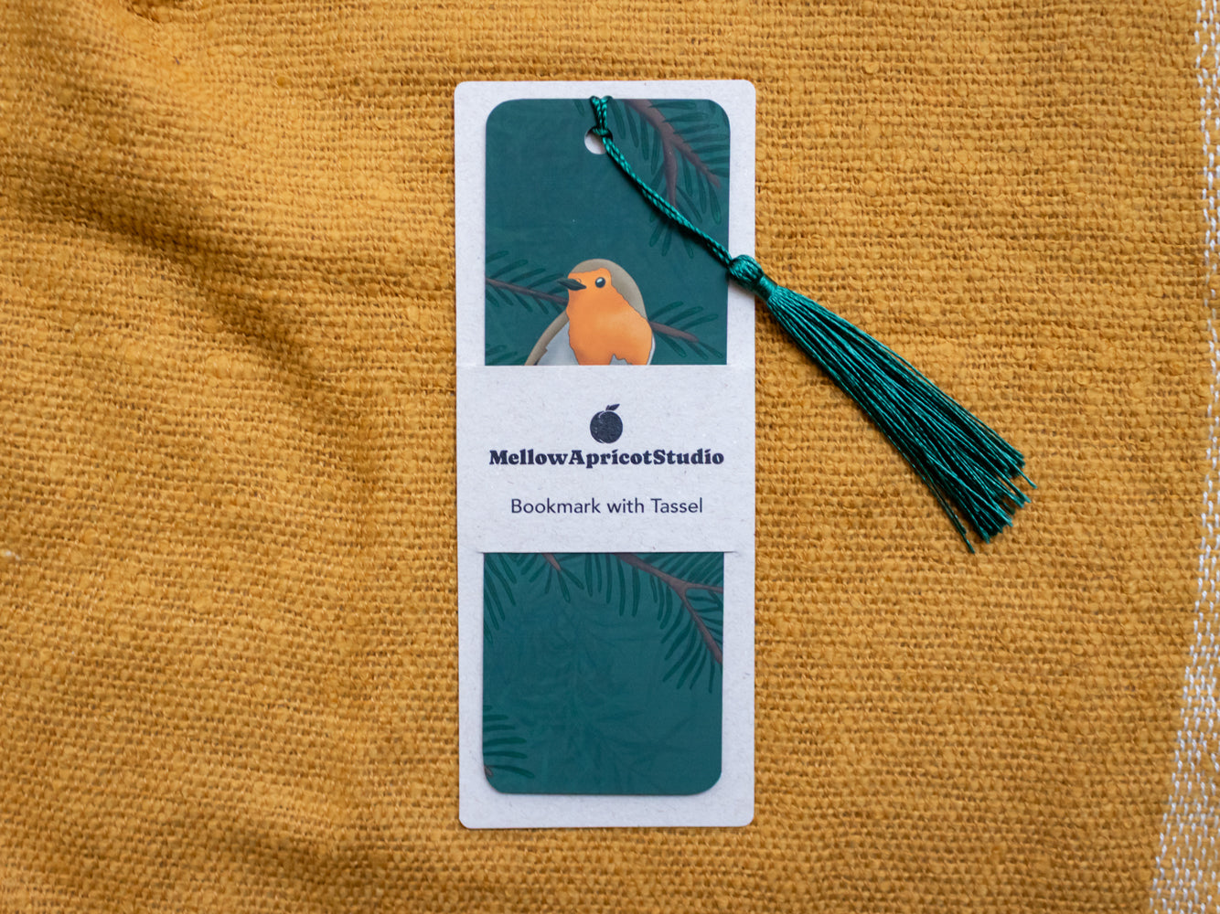 Robin bookmark with tassel in card sleeve on a yellow fabric background