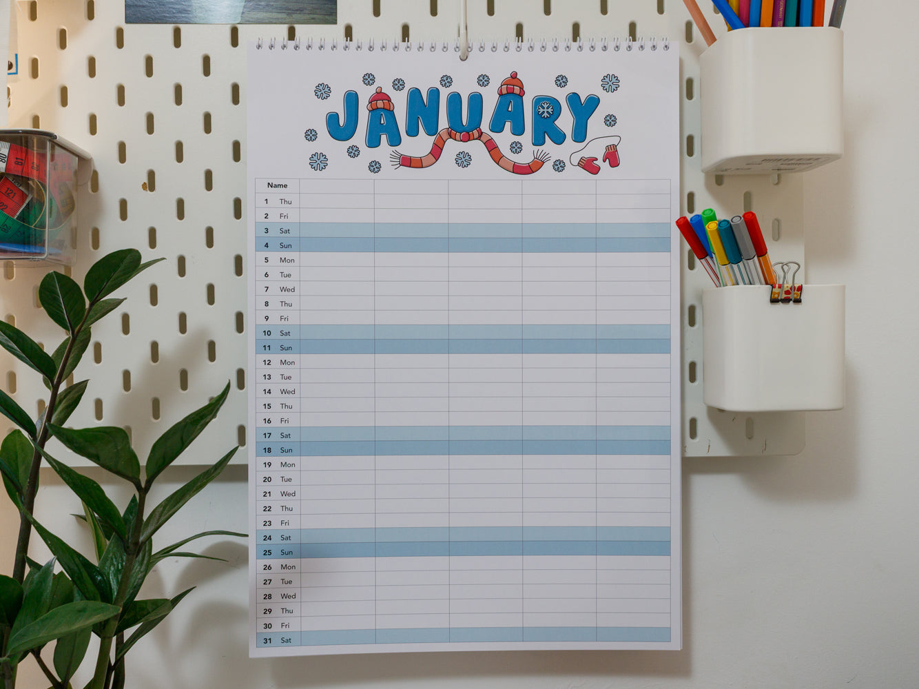 2026 A3 Family Planner: January page on a wall with stationery items