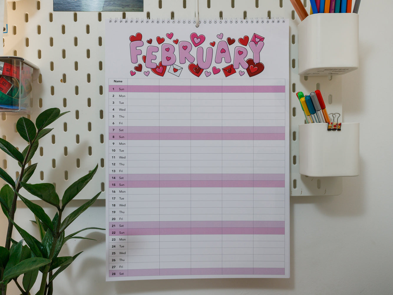 2026 A3 Family Planner: February page with heart designs on a pegboard wall.