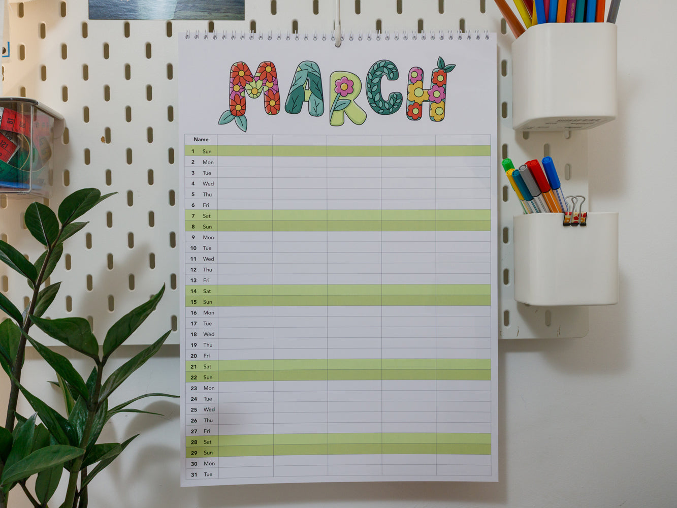 2026 A3 Family Planner: March page on a wall with colourful stationery items.