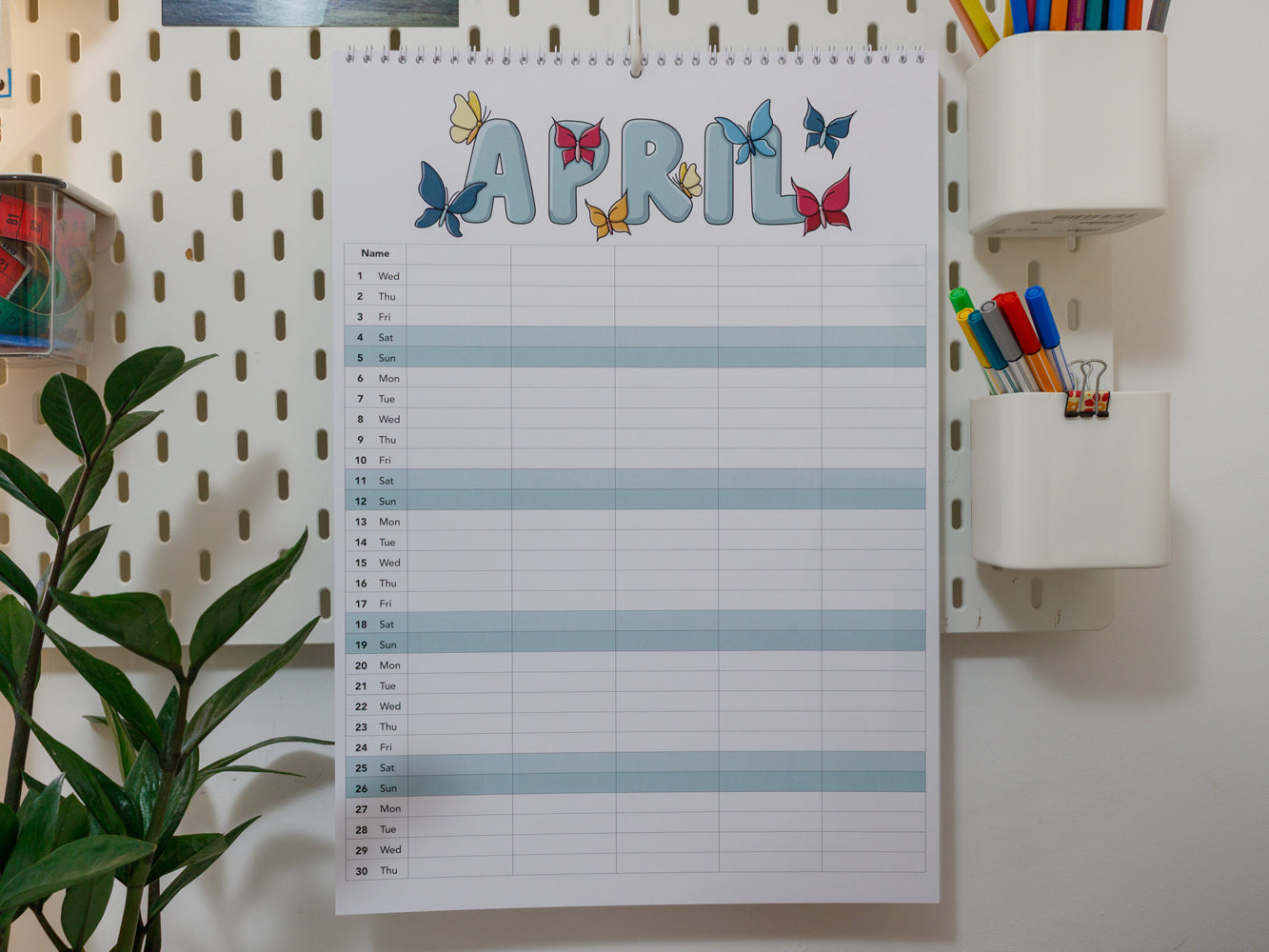 2026 A3 Family Planner: April page on a wall with stationery items