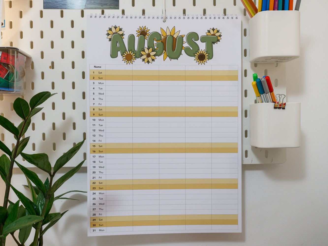 2026 A3 Family Planner: August page on a wall with stationery items
