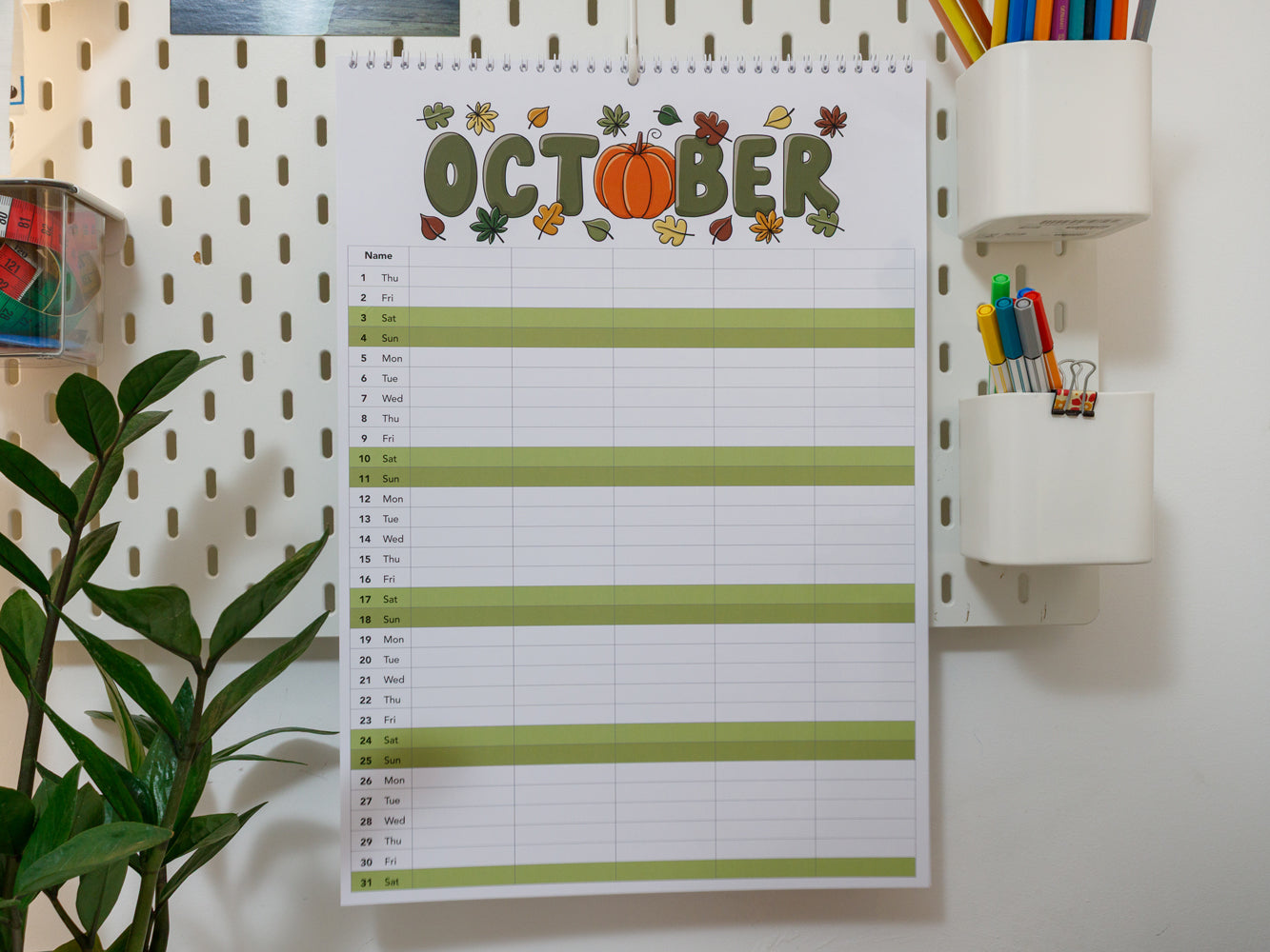 2026 A3 Family Planner: October page on a wall with stationery items