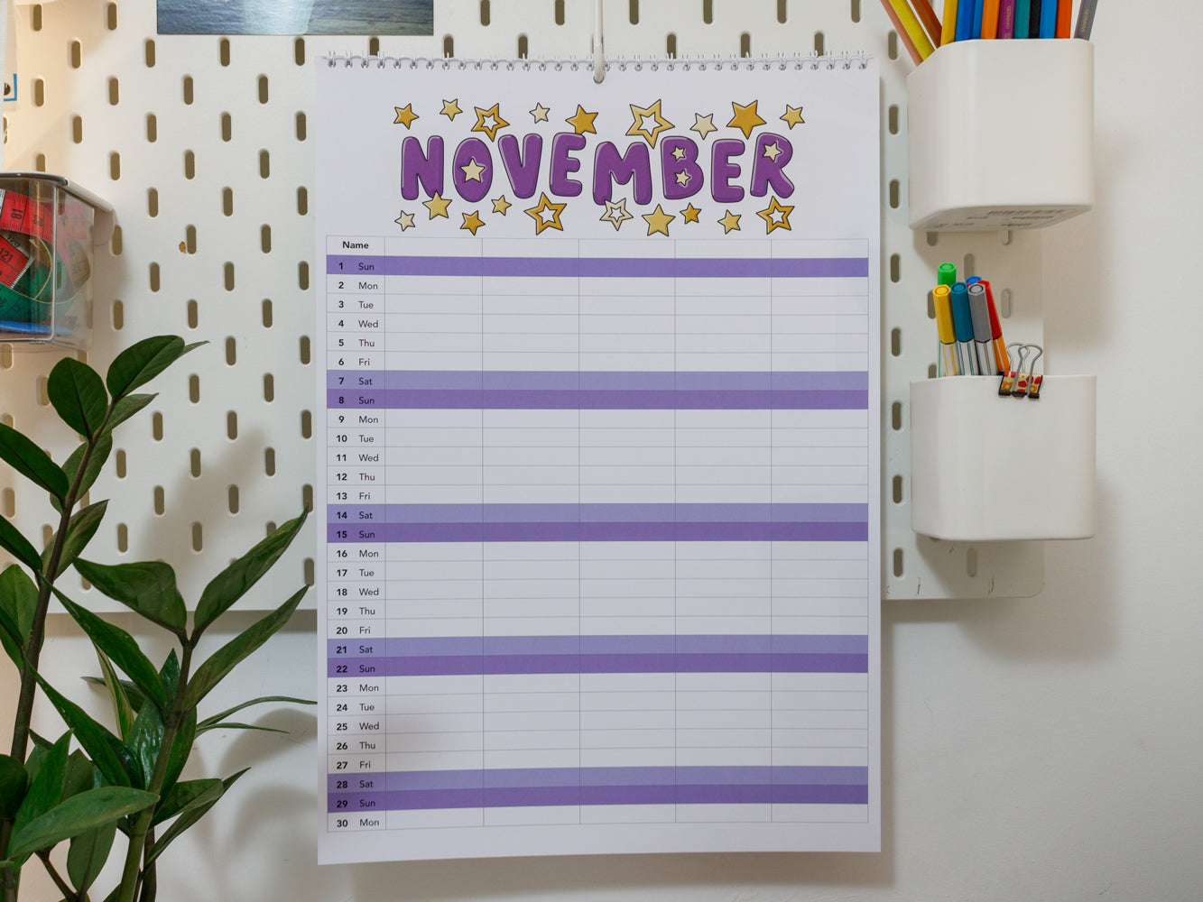 2026 A3 Family Planner: November page on a wall with stationery items