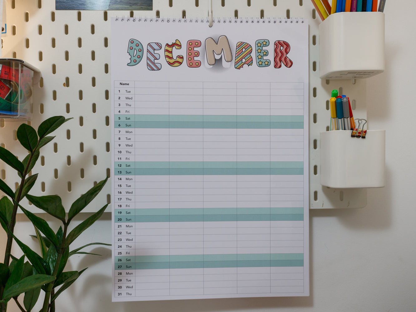 2026 A3 Family Planner: December page on a wall with stationery items