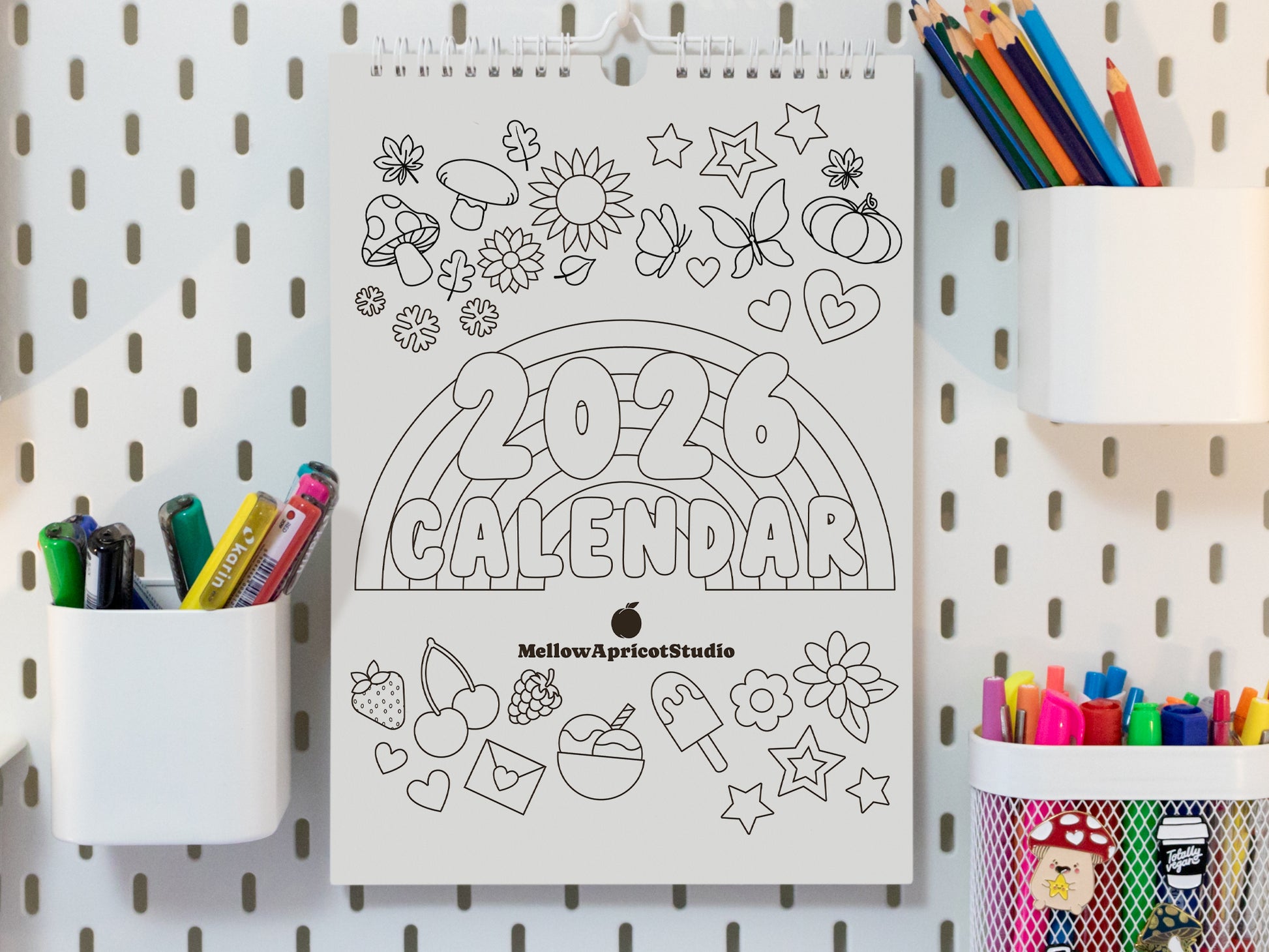 2026 Colouring Calendar on a pegboard with markers and crayons