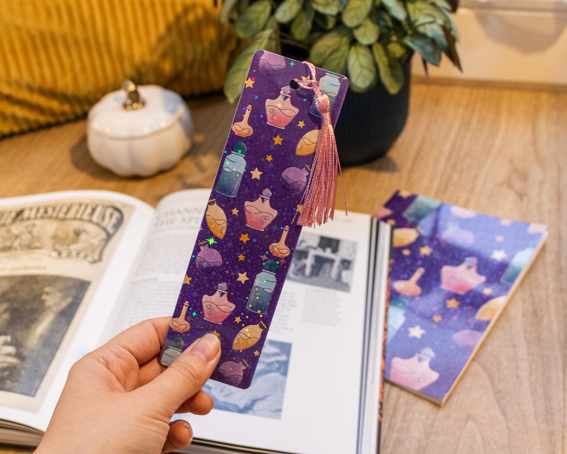 Handmade Bookmark with Tassel and Holographic Magic Potion Pattern - held in hand