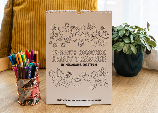 12-Month Colouring Habit Tracker by MellowApricotStudio - cover page in lifestyle setting