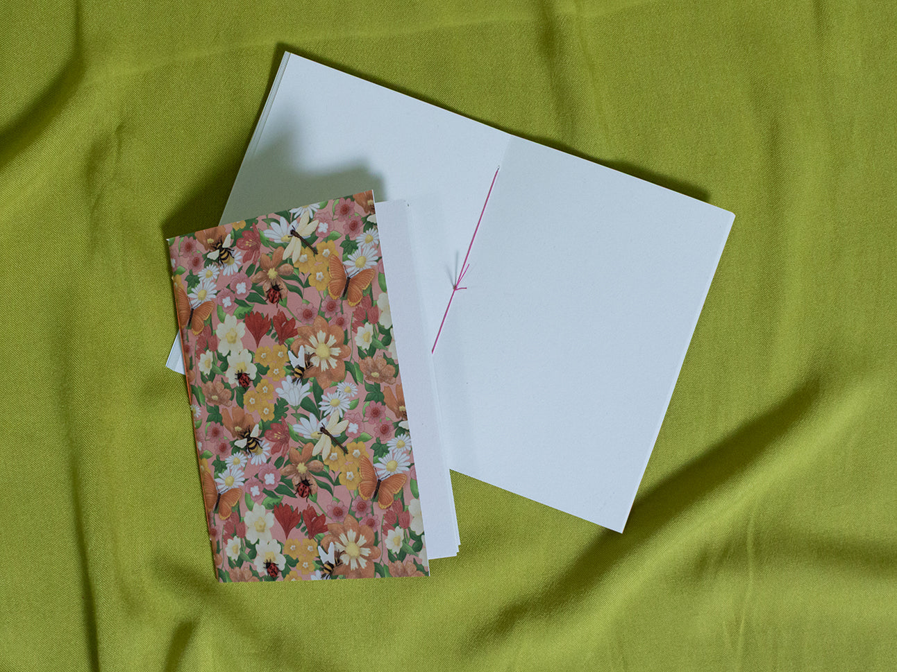 Small floral sketchbook on a green fabric background