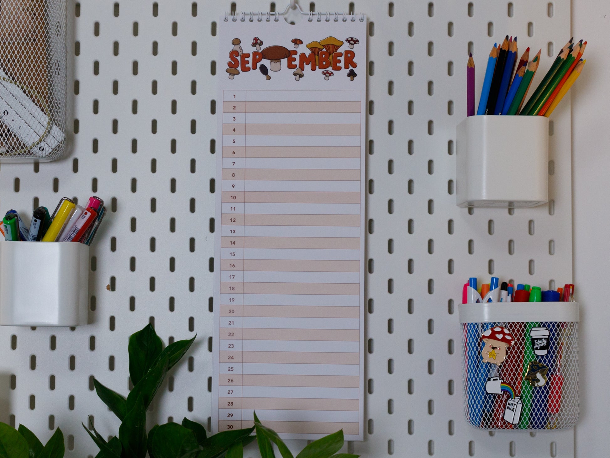 Colourful Perpetual Birthday & Anniversary Planner hanging on office peg board - September with Mushroom Design