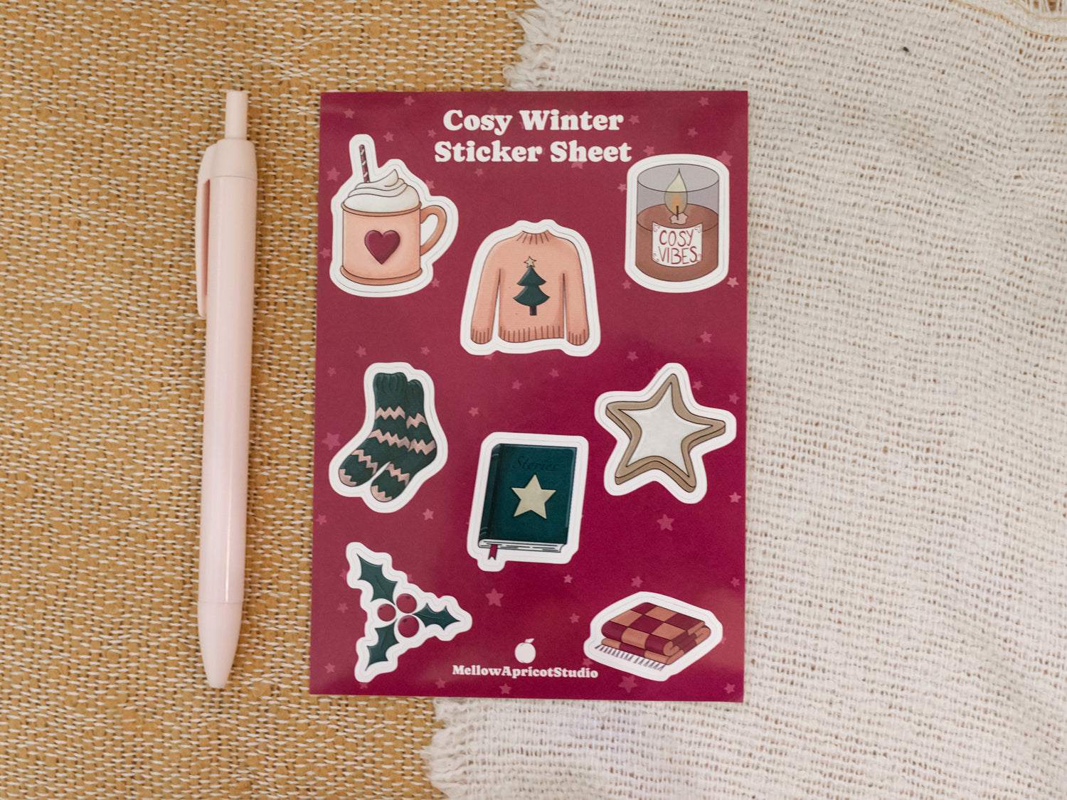 Cosy winter sticker sheet with illustrations on a textured surface