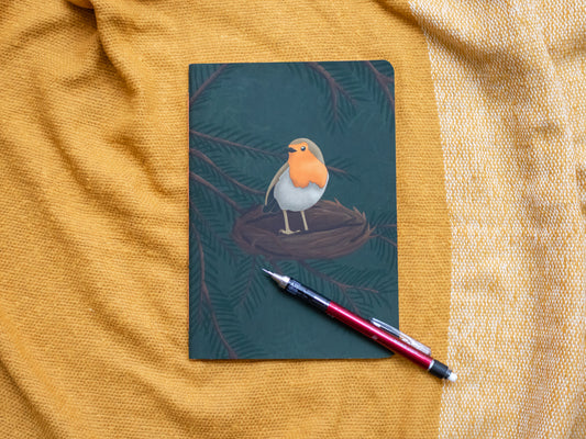 A5 notebook with a robin illustration on a textured yellow surface