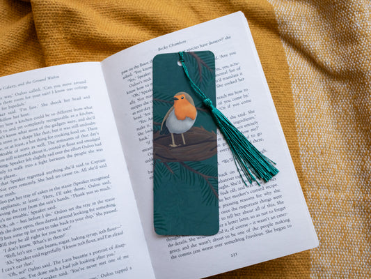 Bookmark with a robin design on an open book against a yellow fabric background
