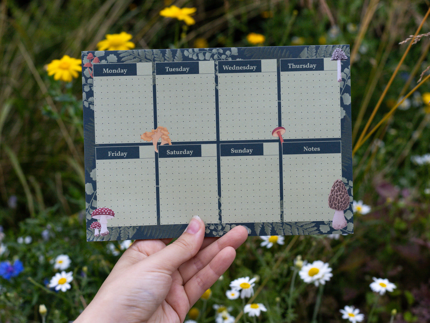 A5 Mushroom and Fern Weekly Planner Pad - Held in hand outside