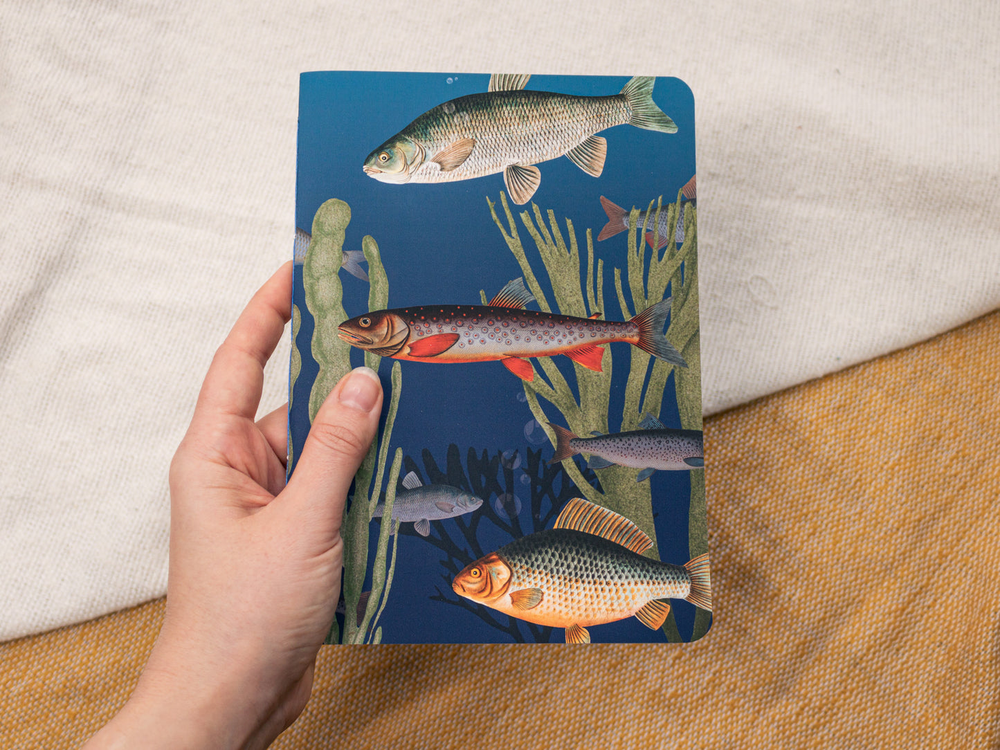 A5 Handmade Notebook with Vintage Fish Design - held in hand