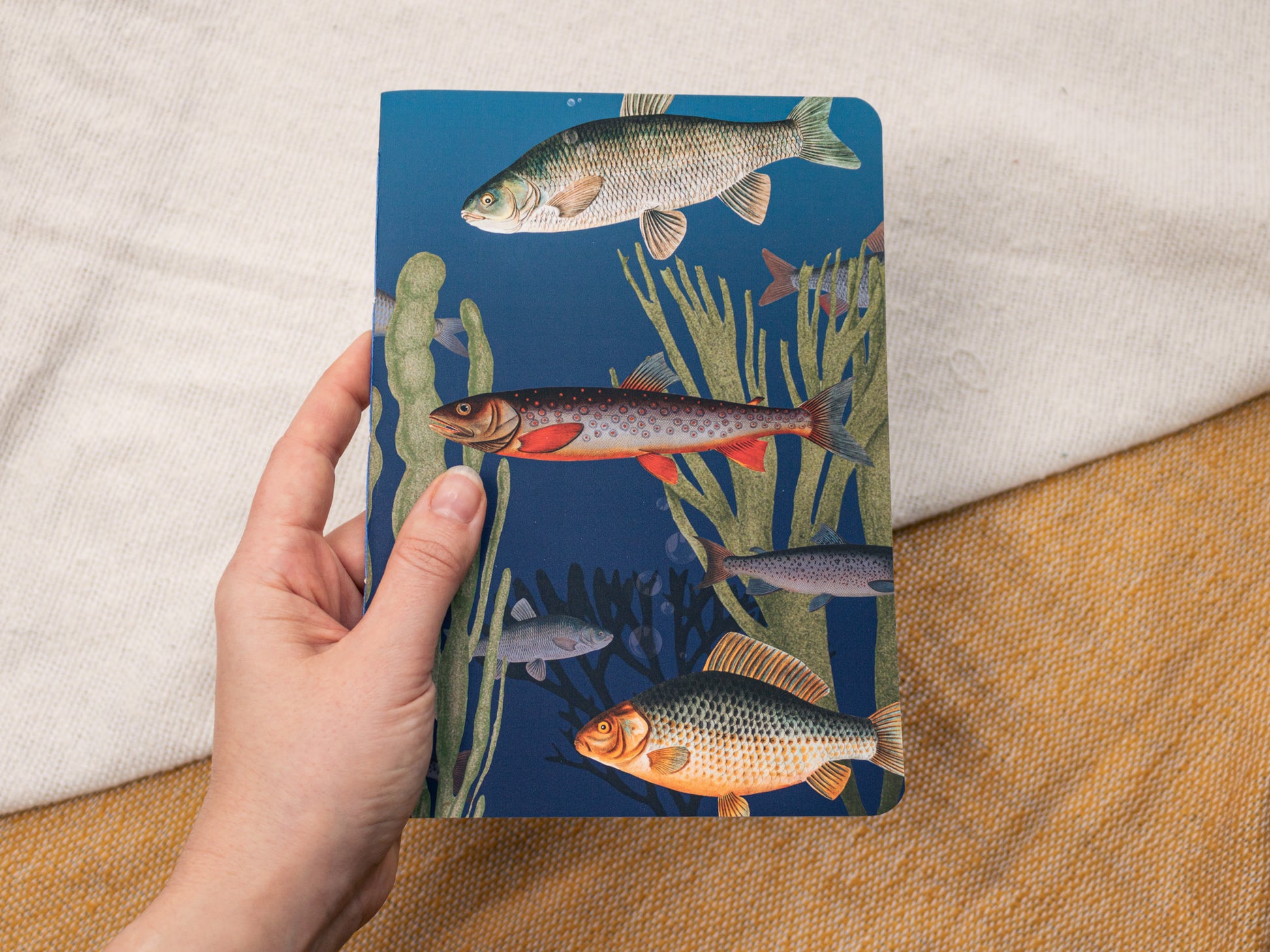 A5 Handmade Notebook with Vintage Fish Design - held in hand