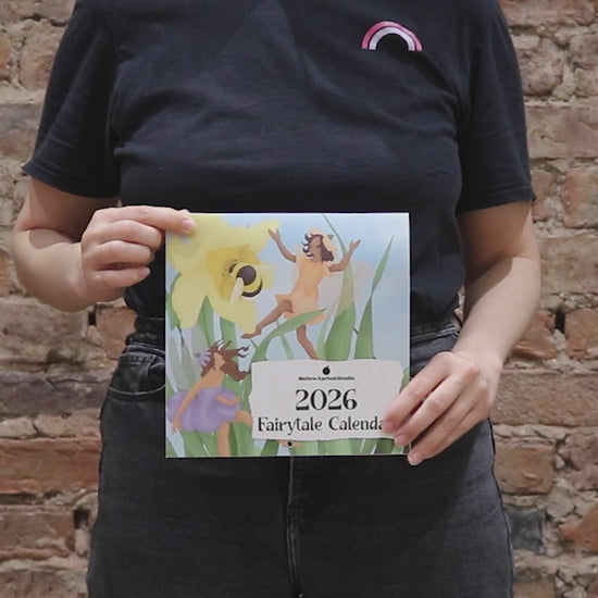 2026 Fairytale Calendar: Person folding calendar and flipping through all the pages