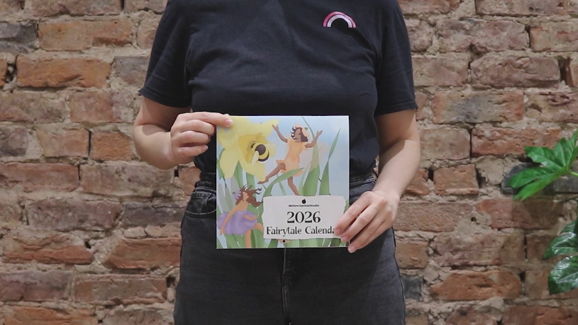 2026 Fairytale Calendar: Person folding calendar and flipping through all the pages