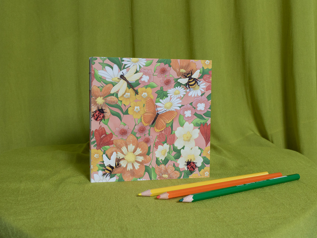 Floral square sketchbook with butterflies and ladybugs on a green fabric background