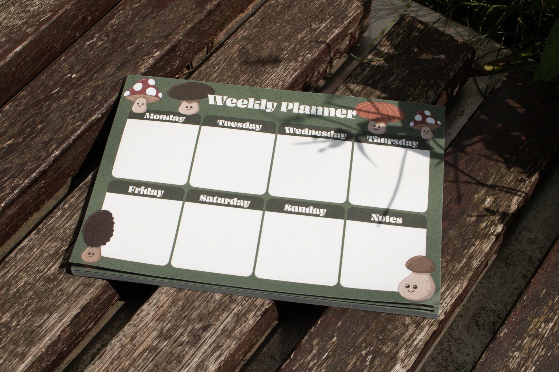 A5 Weekly Planner Pad with Mushroom Design by Mellow Apricot Studio - outside on wood