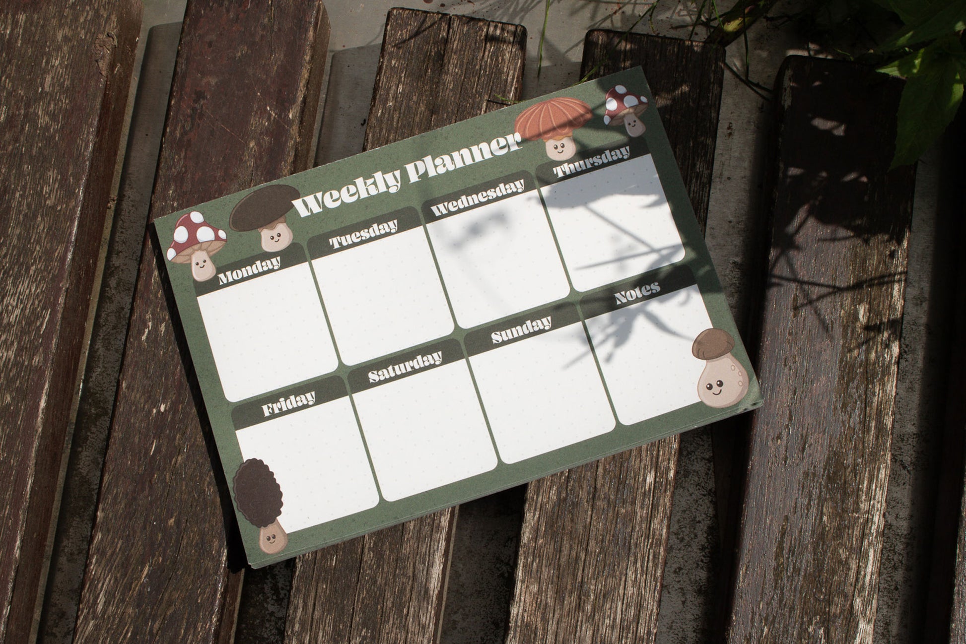 A5 Weekly Planner Pad with Mushroom Design by Mellow Apricot Studio - outside on wood with shadows